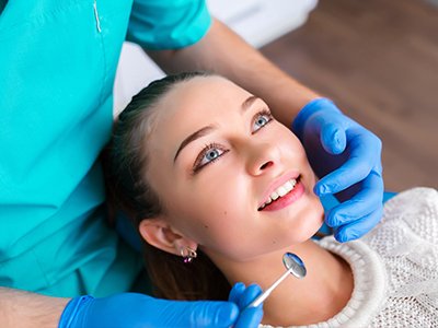 A dentist performing a dental procedure on a patient.